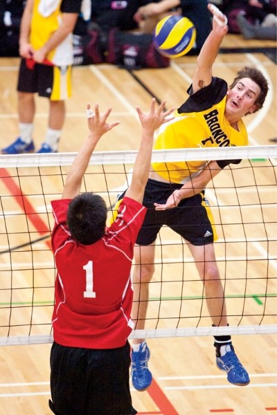 Olds College Broncos player Kennan Hedley spikes the ball during the Broncos game against the SIAST Kelsey Amaruks at the Ralph Klein Centre last Saturday.