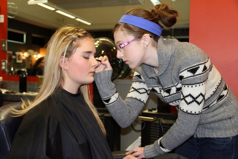 OHS student Kayla Urbanowski benefited from the help of cosmetology student Carly Smith before each performance of Annie Get Your Gun.