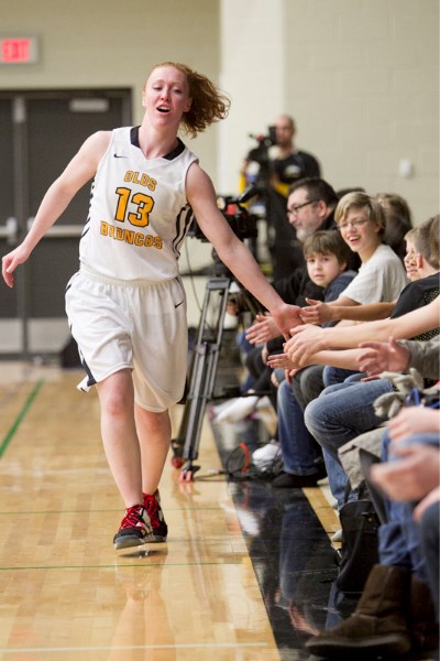 1-Olds College Broncos varsity player Jerri-Lyn Chisholm high-fives people in attendance at the team&#8217;s pep rally celebrating its Alberta Colleges Athletic Conference