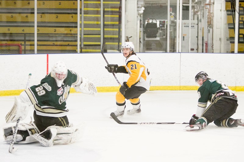 Olds Grizzlys player Matthew Marcinew attempts a shot on the Okotoks Oilers goalie during their playoff game at the Olds Sportsplex last Saturday. The Grizzlys lost the game