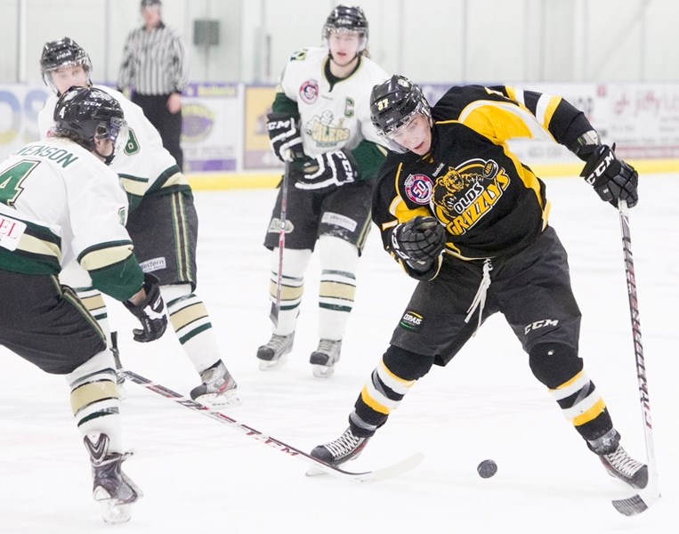 Olds Grizzlys player Ty Mappin tries to get past an Okotoks Oilers player during their game at the Olds Sports Complex on Jan. 7. The Oilers won the game 5-3. CLICK ON