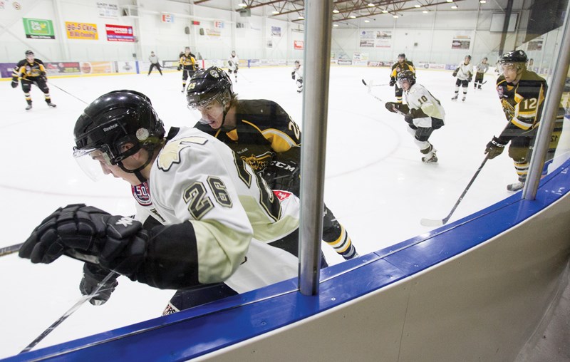 Olds Grizzlys player Jack Goranson fights for the puck during the Grizzlys&#8217; game against the Bonnyville Pontiacs at the Olds Sports Complex on Jan. 18. The Grizzlys won 