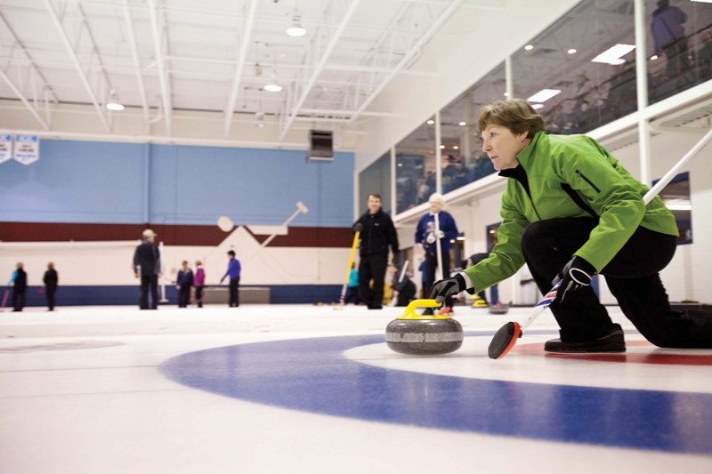 Betty Richardson releases a rock during the 2012 Olds Farmers and Farmerettes Bonspiel. This year&#8217;s event begins on Feb. 11.