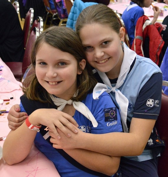 From left: Girl Guides Jessica Toews and Emily Prevost celebrate the organization&#8217;s 100th year in Olds on Feb. 24.