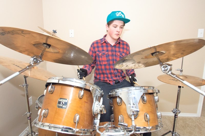 Bryce Cotton performs on his drums at his home on May 2. Cotton received a gold medal last week from Canada&#8217;s Royal Conservatory of Music for his percussion skills.