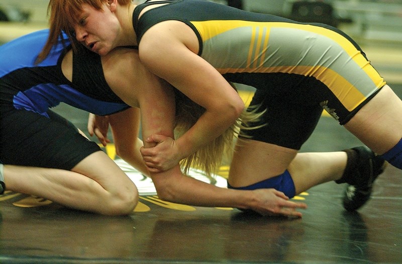 Amber Maschke, seen here wrestling for the Olds High School Spartans at the age of 16, is currently raising cash to attend and compete at several national and international
