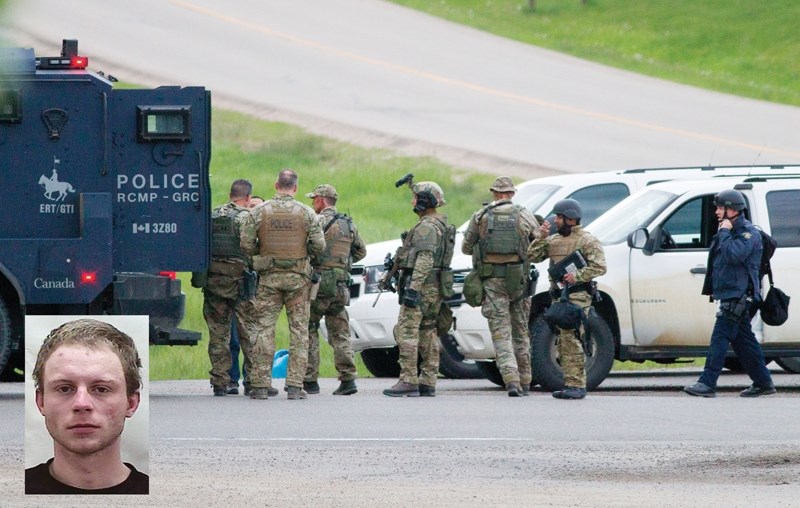Police gear up at a command post near the interchange of highways 2 and 587 on the evening of June 12 to search for a fugitive hiding in a garden nursery north of Bowden.