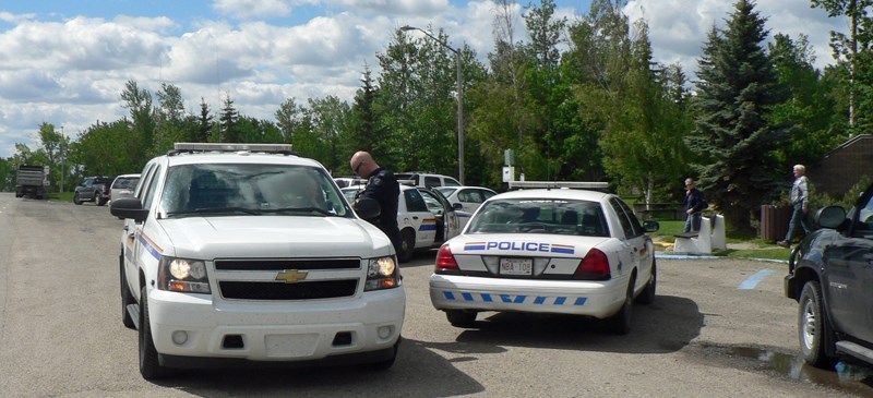 Police work outside the Bowden Heritage Rest Area on June 6 after arresting a suspect connected to an alleged attempted robbery at Kelly&#8217;s Campground near Innisfail.