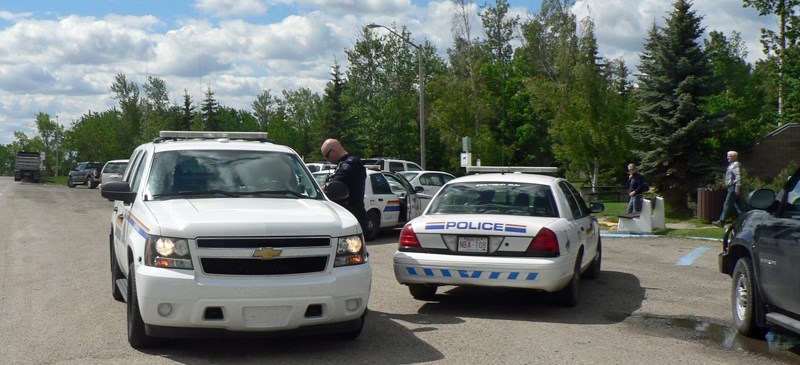 Police work outside the Bowden Heritage Rest Area on June 6 after arresting a suspect connected to an alleged attempted robbery at Kelly&#8217;s Campground near Innisfail.