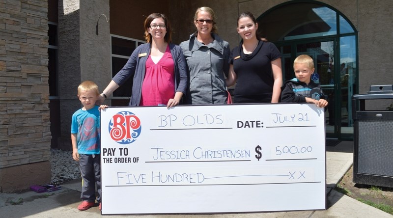 On July 21, Boston Pizza gave $500 to Jessica Christensen (centre), who was diagnosed with thyroid cancer in October. She said the money, which came from Boston Pizza&#8217;s 