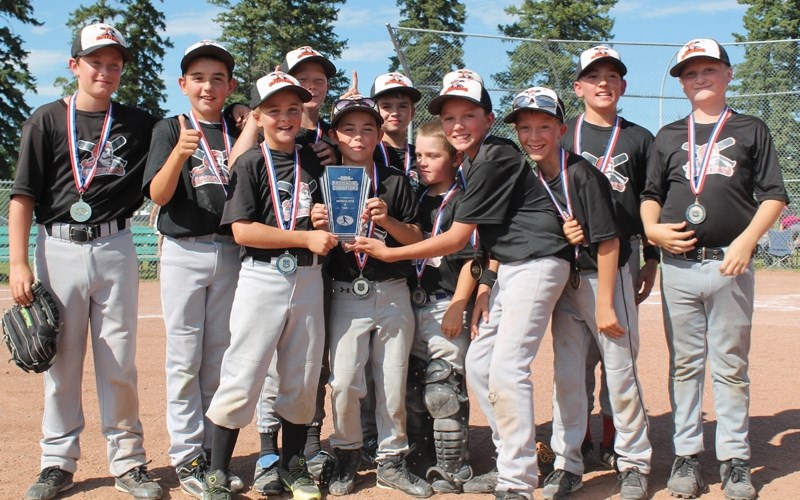 Members of the Olds Spitfires mosquito Tier 1 A team show off the plaque they accepted on the afternoon of July 27 at the O.R. Hedges Park baseball diamonds signifying their