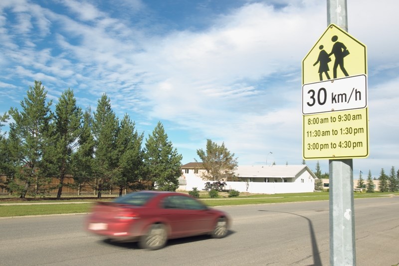 A vehicle passes through the school zone area of Deer Meadow School on Aug. 28.