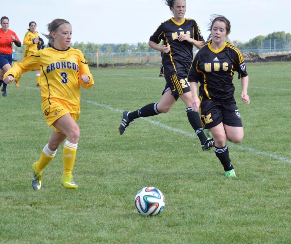 On left, Amber Wolf of Olds, made her home debut for the Olds College women&#8217;s soccer team on Sept. 13 at Normie Kwong Park. The Broncos midfielder is in her first year