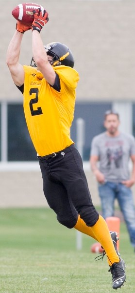 Olds Spartans player Dwayne Neustaeter catches a pass during the Spartans game against the Bishop Carroll Cardinals at Normie Kwong Park on Sept. 18. The Cardinals won the