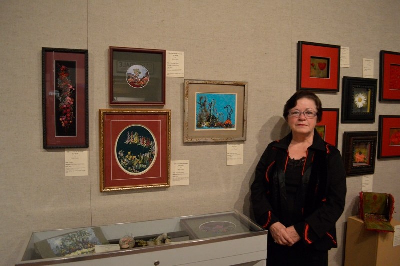 Local artist Betty Caskey stands for a photo next to her artwork on Oct. 2. Until Oct. 30, the Mountain View Museum and Archives in Olds will be holding an exhibit of