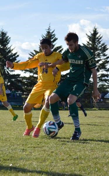 Olds College Broncos striker Qaseem Yusofi battles for the ball against Lakeland College Rustlers midfielder Lewis Isle on Oct. 4 at Normie Kwong Park.