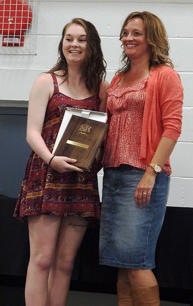 Chelsey Jasper receives her Most Outstanding Grade 12 award from Ms. Patti Cummins.