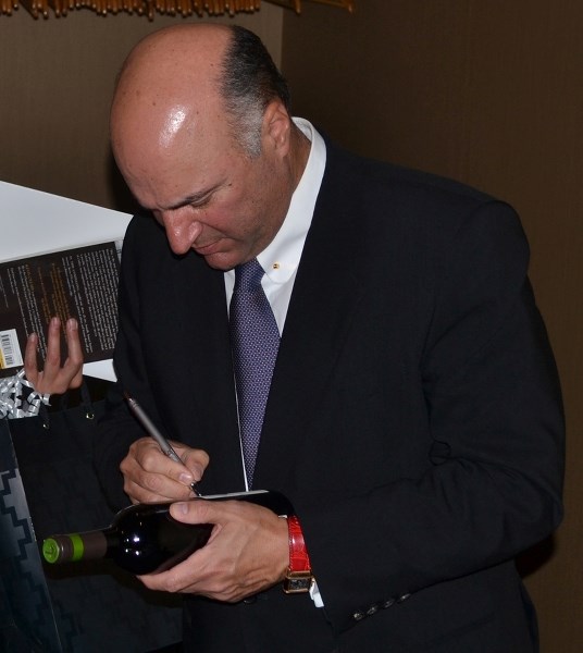 Kevin O&#8217;Leary signs a wine bottle. Kevin O&#8217;Leary wine was made available during his presentation at the Pomeroy Inn and Suites Oct. 6.