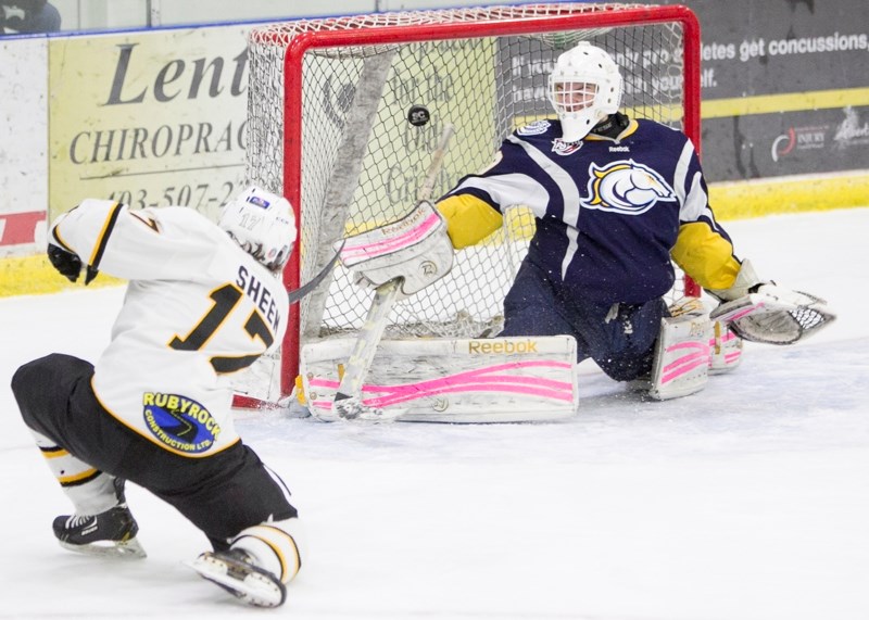 Olds Grizzlys player Colton Sheen scores on the Calgary Mustangs goaltender during the first period of a game at the Olds Sportsplex on Oct. 31. The Mustangs won the game 3-2.