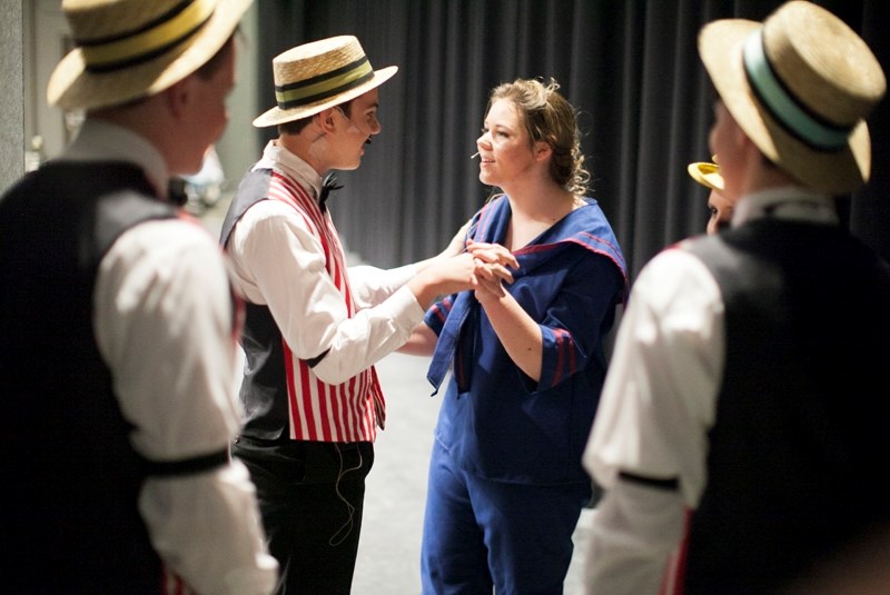 Olds High School students Terence Kelly, left, and Tatum Olsen share a moment together backstage during a dress rehearsal for &#8220;Music Man&#8221; at the TransCanada
