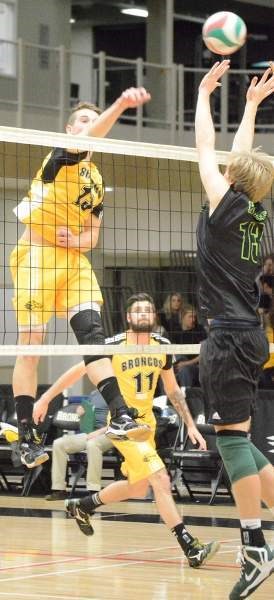 First-year Broncos middle Zack Deacon spikes the ball during his team&#8217;s match against the Red Deer College Kings on Nov. 22 at the Ralph Klein Centre. Deacon finished