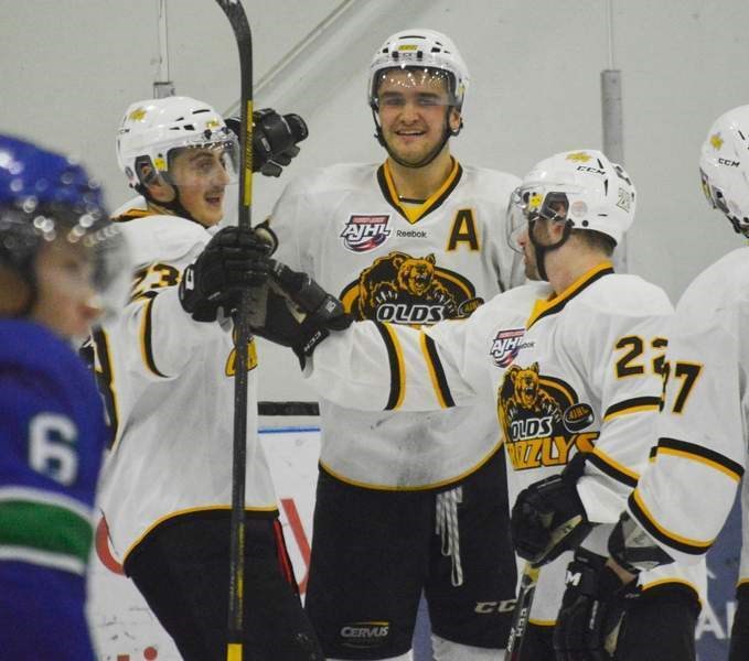 Olds Grizzlys forward Austin Kernahan (middle) celebrates his 10th goal of the year, scored against the Calgary Canucks at the Olds Sportsplex on Nov. 25. The Grizzlys won