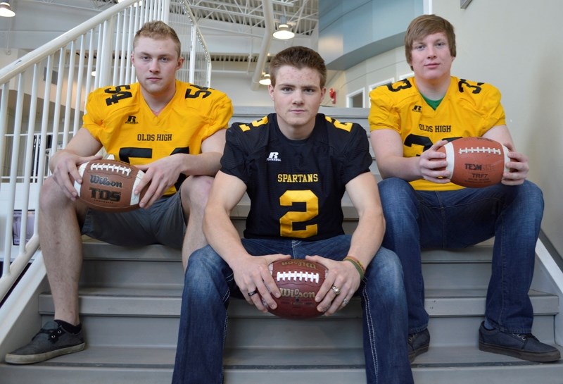 From left, Brody Dirk, Dwayne Neustaeter and Ryland Couture of the Olds High School football team. Along with teammates Tylen Smith and Cole Jacobson (not pictured), the