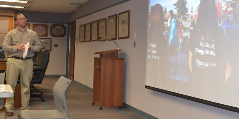 Olds chief operating officer Doug Wagstaff plays an Anonymous Good video featuring a song written by local musician Ryan Notley.