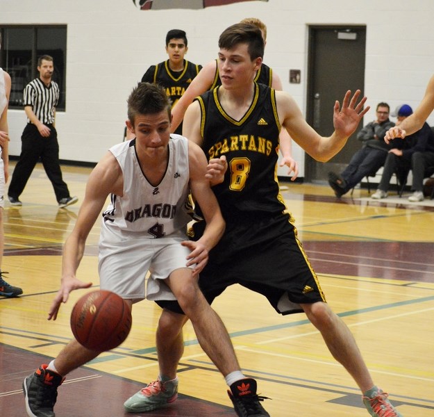 Kempton McAllister of the Olds High School senior boys basketball team guards an opponent during a game against the Didsbury High School Dragons on Dec. 17 in Didsbury.