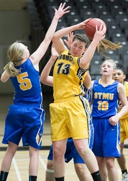 Olds College Broncos women&#8217;s basketball player Melanie Thera fights for a rebound during the Broncos&#8217; game against the St. Mary&#8217;s University Lightning at