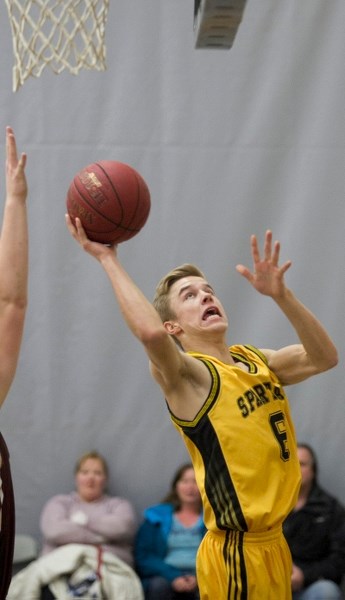 Olds Spartans senior basketball player Baylen Unger drives to the hoop.