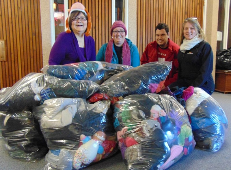 Posing with clothing collected via the Olds College Residence Life Department clothing challenge are (from left to right) Deborah Trehearne, co-ordinator of Coats for