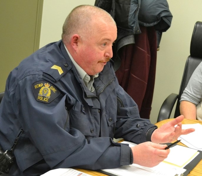 Olds RCMP detachment commander Staff Sgt. Joe Sangster makes a presentation to Bowden town council.