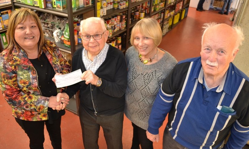 Local Co-operators financial advisor-owner Giselle Wilson (far left) presents a cheque for $500 on behalf of the company to Mountain View Food Bank treasurer Harry Warne.