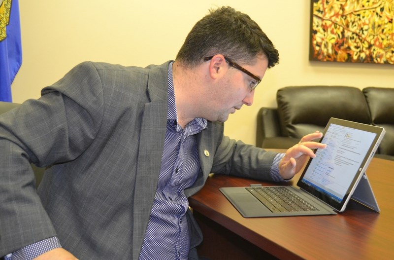 Olds-Didsbury-Three Hills MLA Nathan Cooper does some research via his laptop.