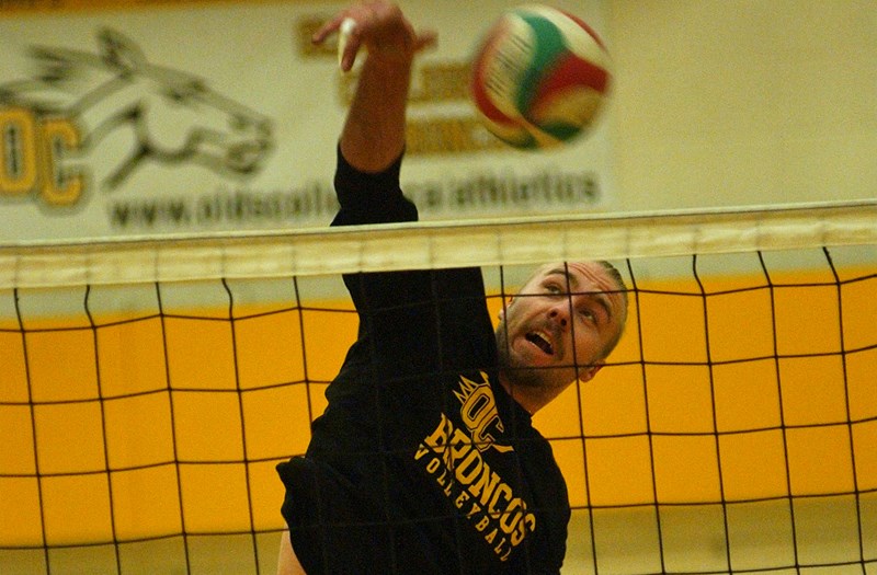 Decker Mainil, a second-year middle player on the Broncos men&#8217;s volleyball team, spikes the ball in practice on Jan. 27 at Frank Grisdale Hall. The team had just won