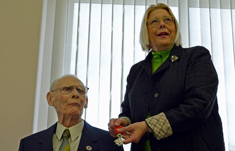 Olds mayor Judy Dahl presents George Arden with a medal on March 11 recognizing his service in the Second World War. Arden was awarded the rank of Knight of the French