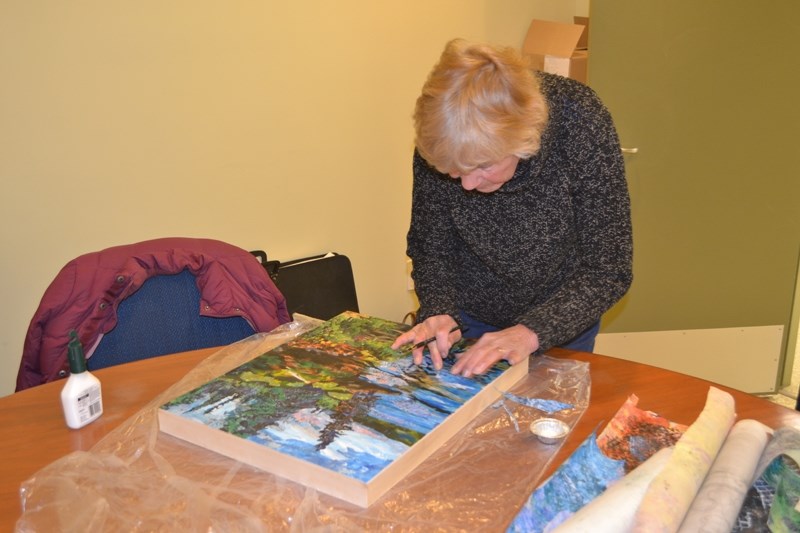 Anne Burchill, the featured artist in this weekend&#8217;s Olds Art Club Show and Sale at the legion, demonstrates the collage technique she loves.