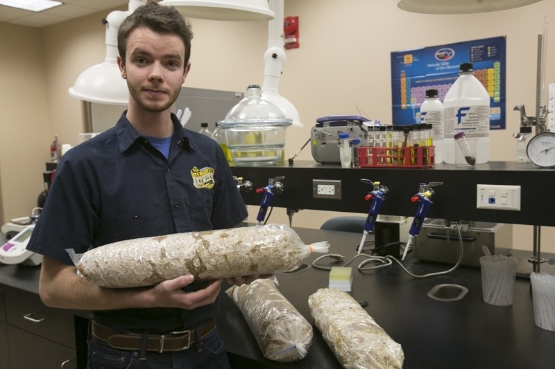 Olds College student Alex Villeneuve with some samples of spent grain at the Bio Industry Resource Centre.