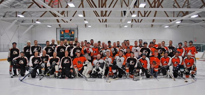 BJ Poulsen (right), an alumni player and Bowden resident during action at the March 26 recreational hockey event.