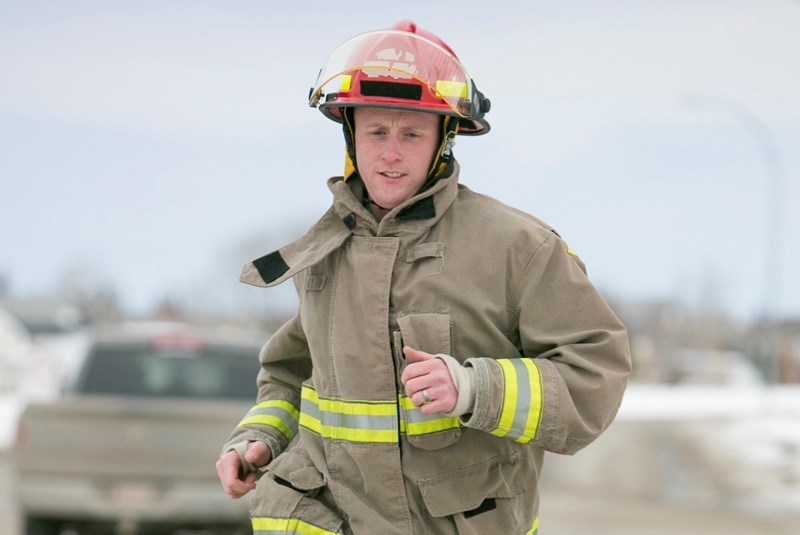 Olds firefighter Noel D&#8217;arcy runs near the firehall earlier this year.