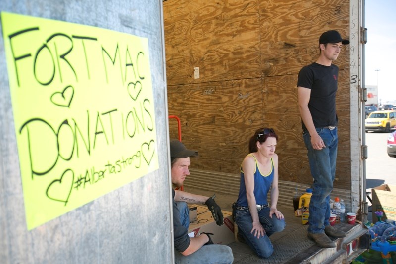 From left Adrien Woods, Nicole Wales and James Carter wait to load items into the trailer.&lt;br /&gt;Noel West/MVP Staff&lt;br /&gt;From left Adrien Woods, Nicole Wales and