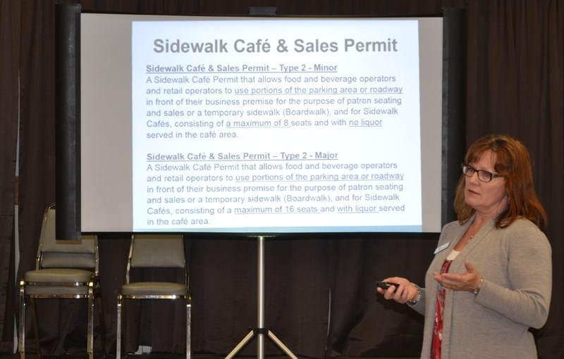 Development officer Carey Keleman outlines aspects of the sidewalk cafe bylaw during an open house at the Olds Legion.
