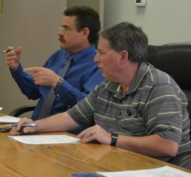 Bowden chief administrative officer James Mason (left) explains aspects of the town&#8217;s 2016 budget while Coun. Paul Webb looks on.