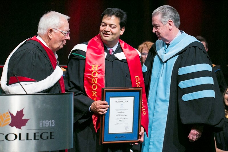Board of governors chair Bob Clark, left, and president Tom Thompson, right, present Saajid Khan with an honorary degree during this year&#8217;s Olds College graduation