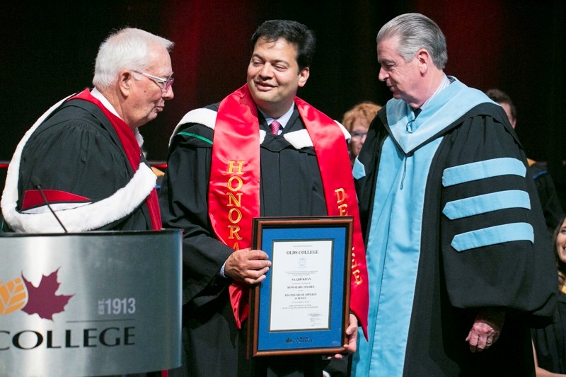 Board of governors chair Bob Clark, left, and president Tom Thompson, right, present Saajid Khan with an honorary degree during this year&#8217;s Olds College graduation