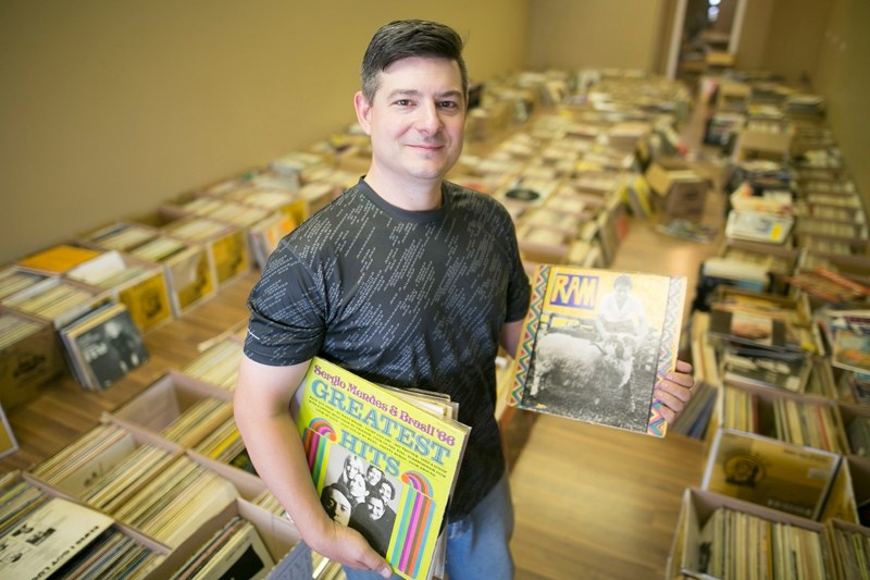Jed Butters with some of the thousands of records he has for sale in Olds.