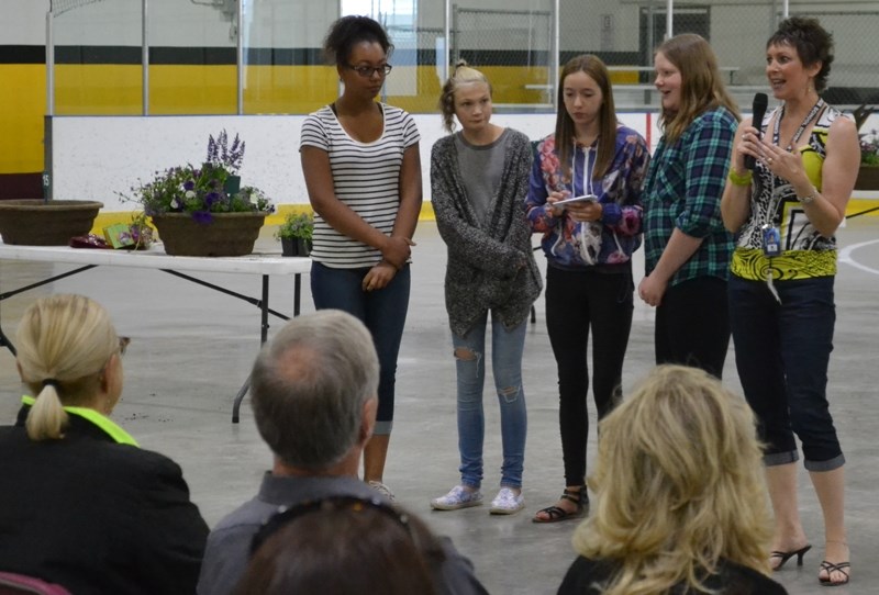 Teacher Lori Clarke (far right) and some members of the Deer Meadow School gardening academy thank Communities in Bloom (CIB) for a donation they received and for all the