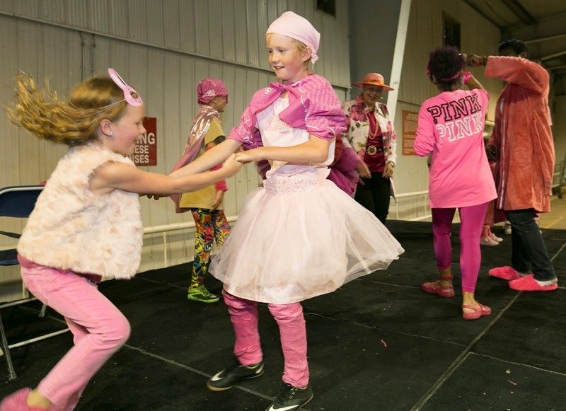 Competitors in the Wild Pink Yonder fashion show dance while waiting for the judges to make their decision.