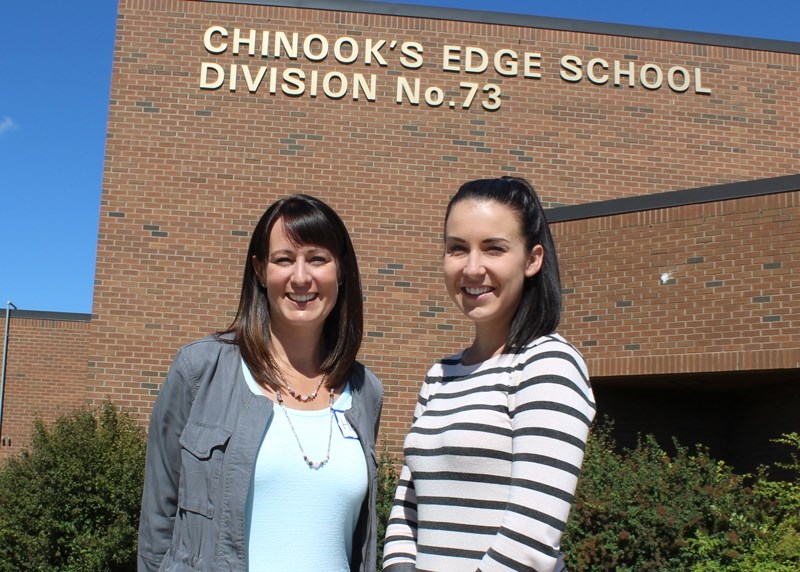 New teachers in Olds and Bowden, Heather Dewling (left) and Emma Turville pose outside Chinook&#8217;s Edge School Division headquarters.